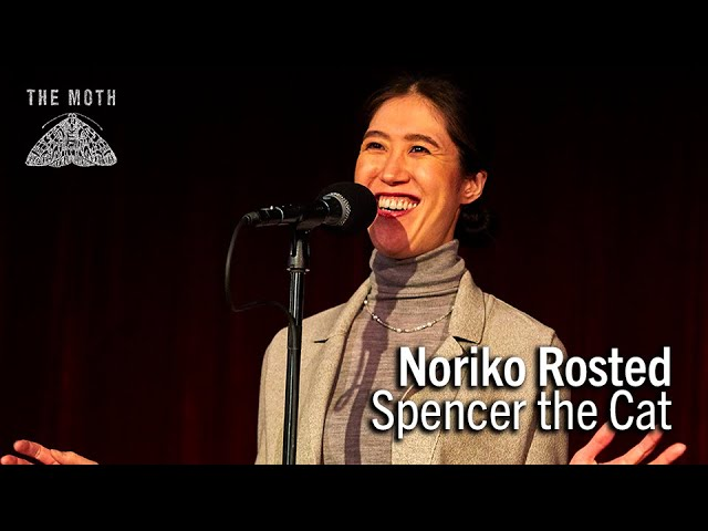 Woman speaking into a microphone, with text overlay "Noriko Rosted Spencer the Cat" and "The Moth" logo on top left.